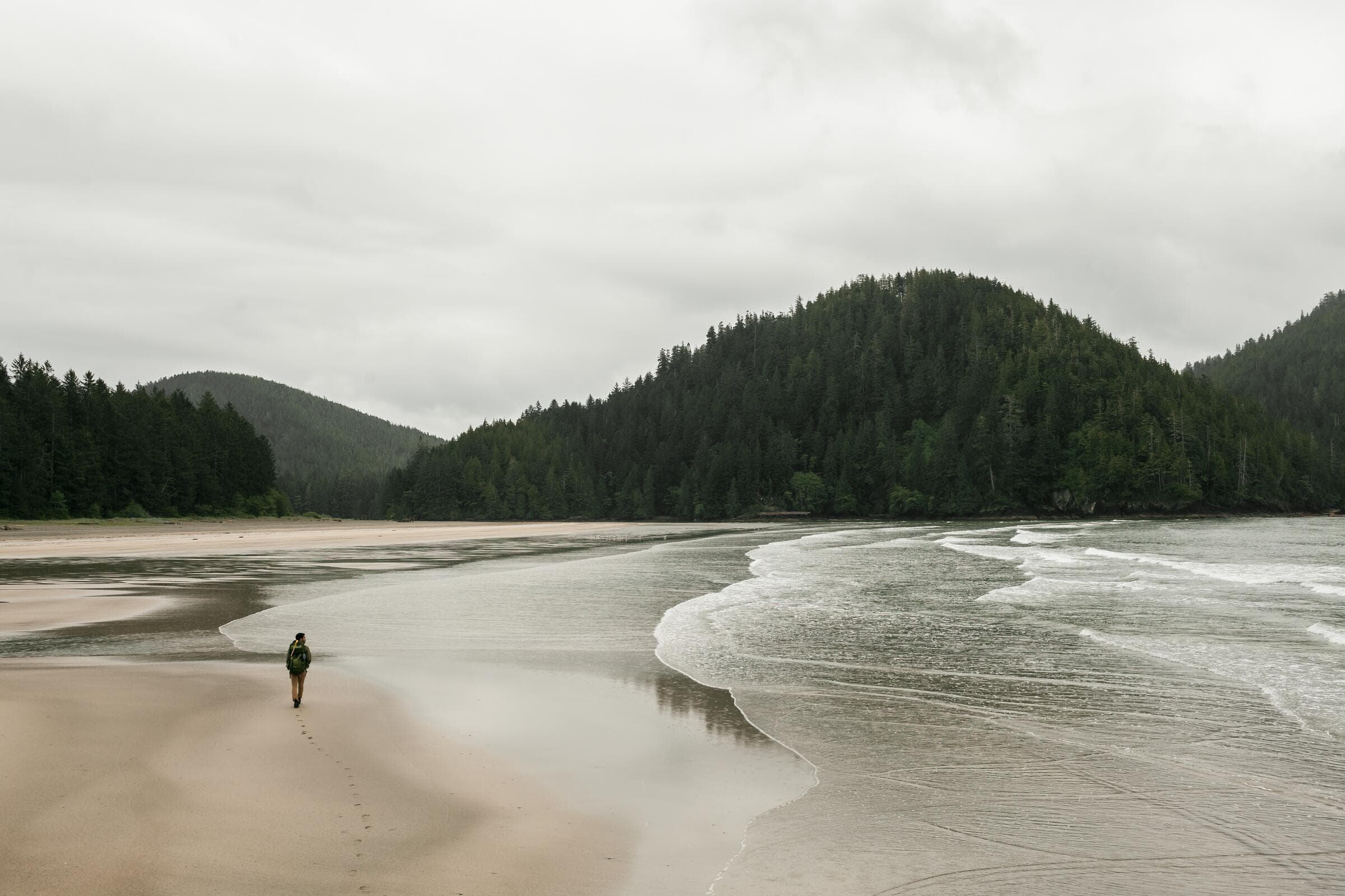 A walker on the wide sand of San Josef Bay in Cape Scott Provincial Park