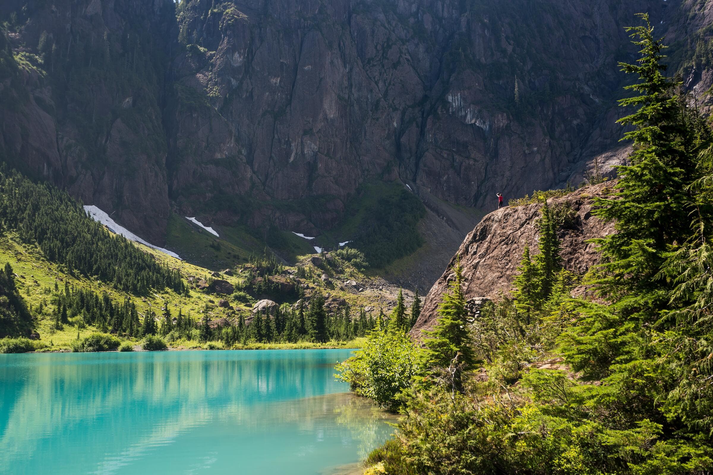 A turquoise alpine lake below cliffs in Strathcona Provincial Park