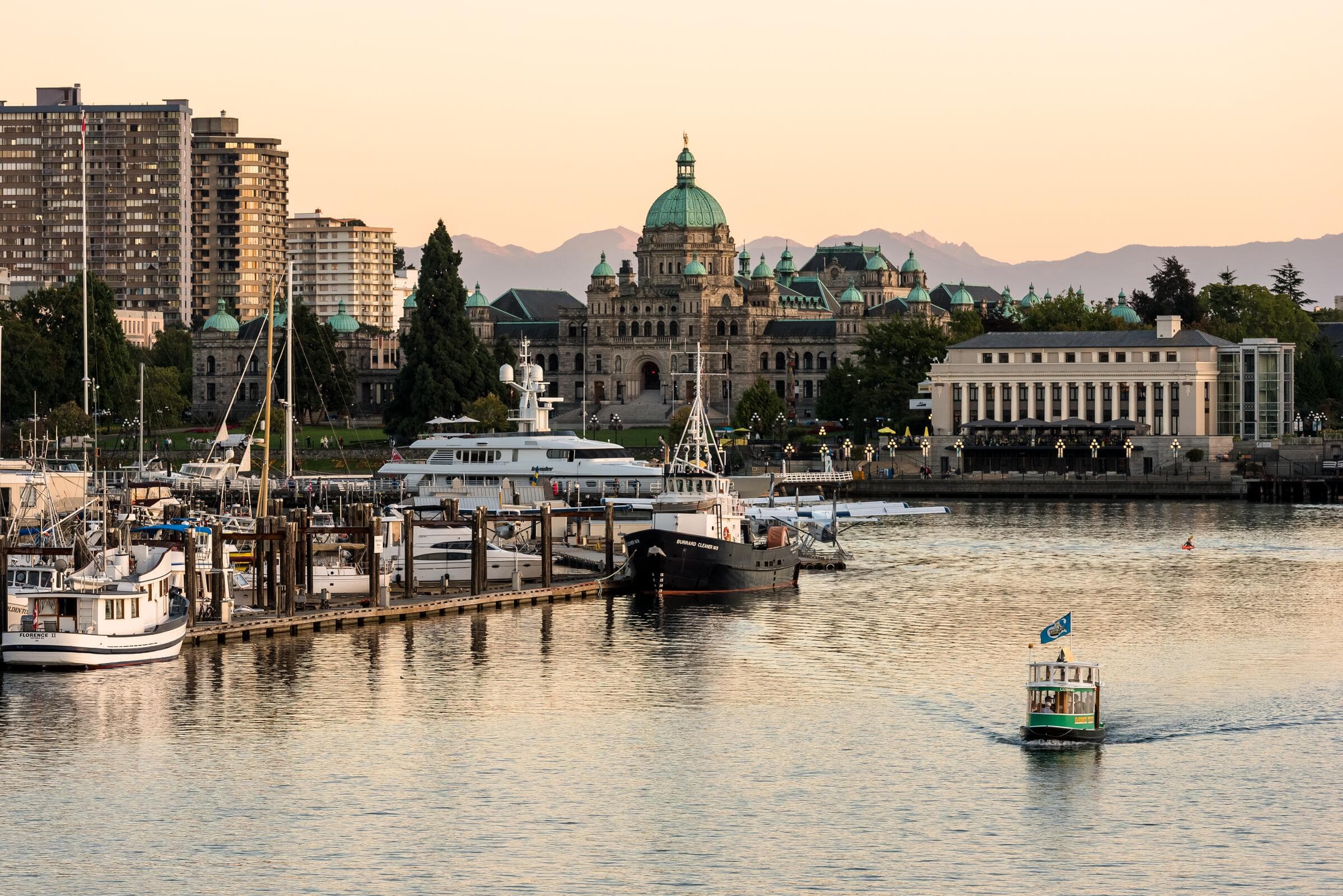 Victoria's Inner Harbour at sunrise with the Parliament Buildings behind the marina