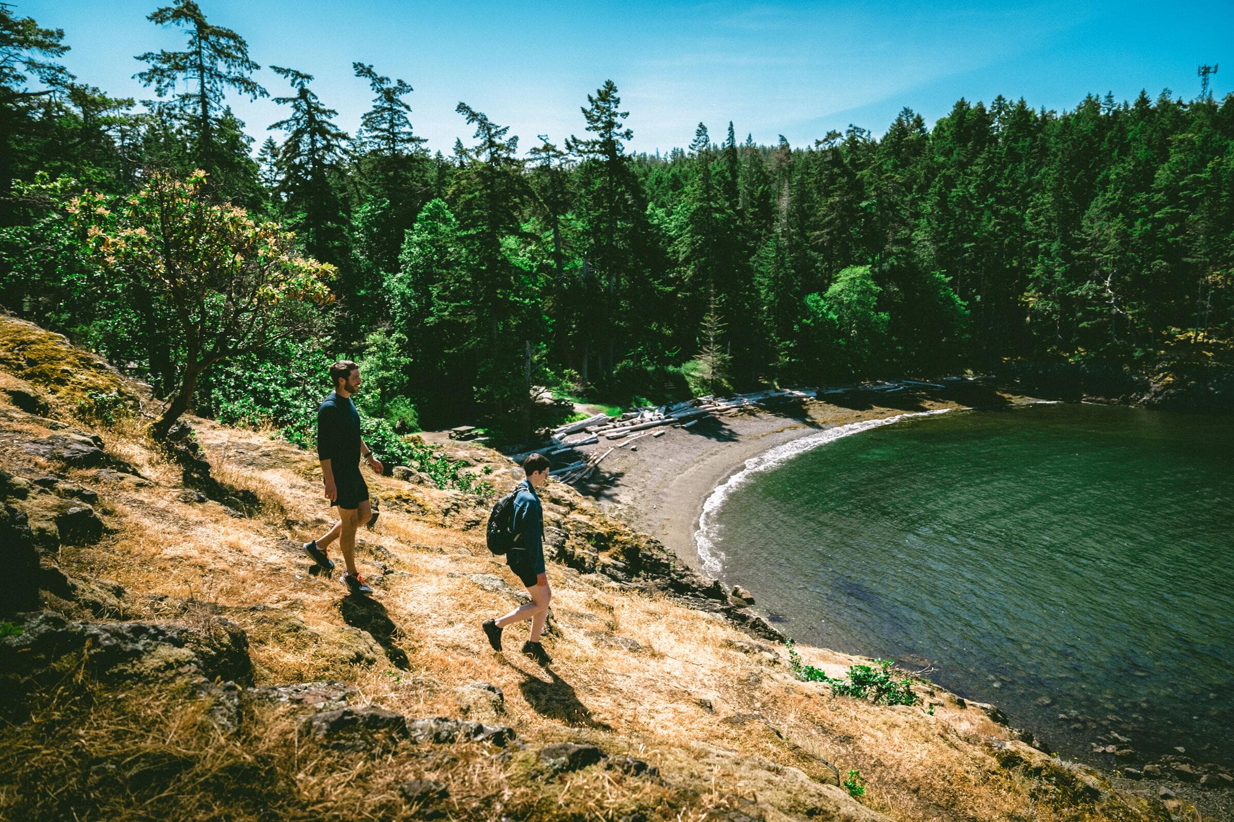 Two hikers above the curved beach at Neck Point Park in Nanaimo